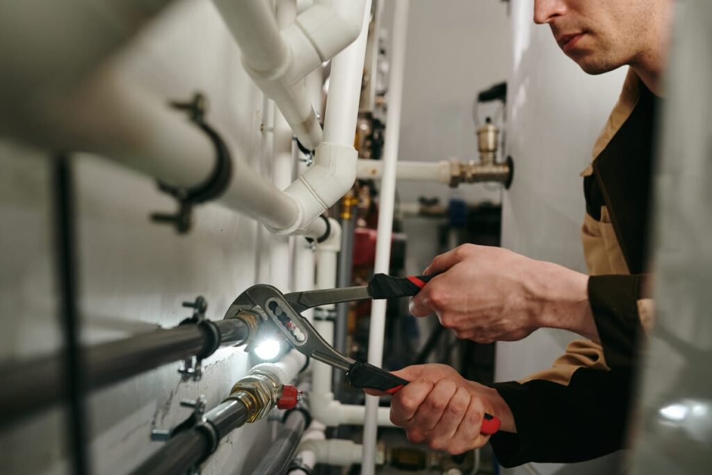 Plumbers maintaining commercial plumbing pipes in Stuart