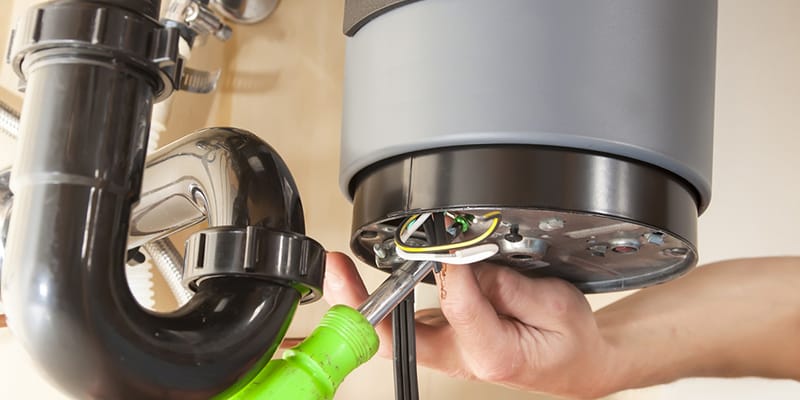 Technician repairing the heating element of a water heater in Stuart